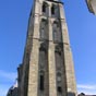 La tour de l'horloge tout comme la tour Charlemagne  sont les seuls  vestiges de l'ancienne basilique médiévale  (IXe siècle-1802). L'église fut incendiée par les Normands le 8 novembre 853, puis à nouveau le 30 juin 903, à la suite de quoi le sanctuaire fut entouré d'une enceinte fortifiée, distincte de celle de Tours, achevée en 918. Il y eut un grand incendie accidentel en 994, ce qui entraîna une reconstruction, sous l'impulsion d'Hervé de Buzançais, alors trésorier de Saint-Martin, et une nouvelle consécration en 1014. Un sinistre eut encore lieu en 1096, et on procéda à un grand remaniement de l'édifice entre 1175 et 1180 : c'était alors une étape importante sur la Via Turonensis du pèlerinage de Saint-Jacques-de-Compostelle. 